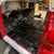 Load image into Gallery viewer, SEMA:black floor install with logos-chevy truck.jpg
